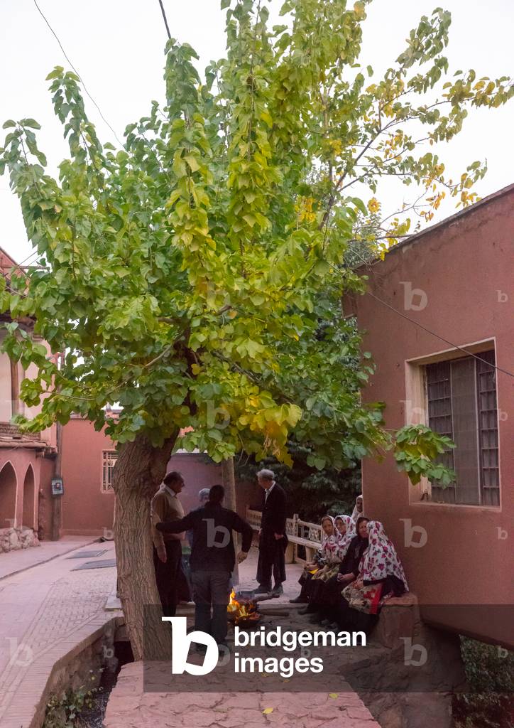 Portrait of Iranian Women wearing Traditional Floreal Chadors and Men in Zoroastrian Village, Isfahan Province, Abyaneh, Iran (photo)