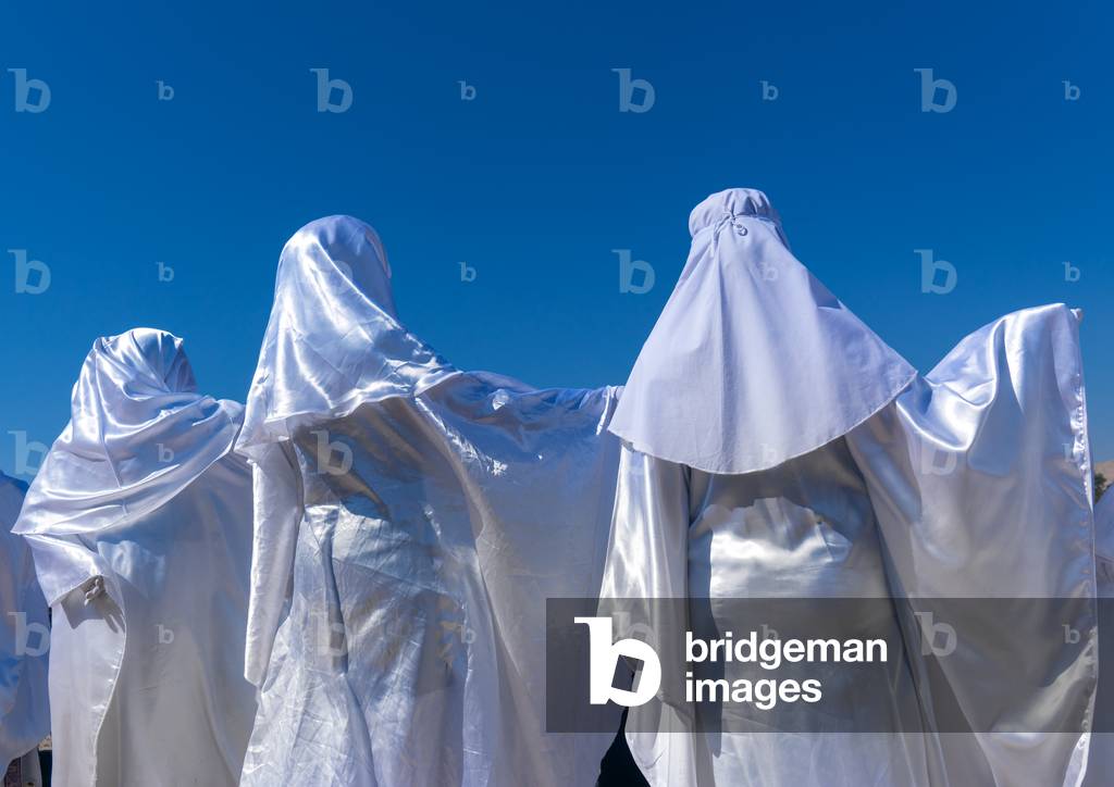 Women in white chadors during a traditional religious theatre called tazieh about Imam Hussein death in Kerbala, Lorestan Province, Khorramabad, Iran (photo)