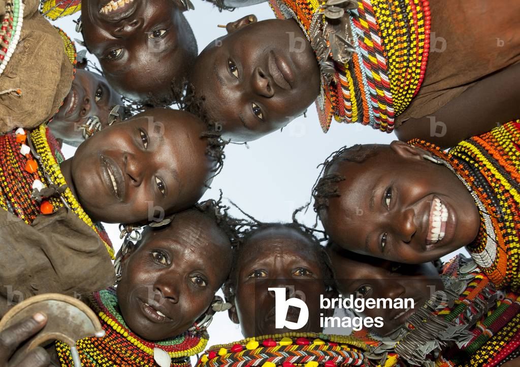 Turkana tribeswomen in circle looking down, Turkana lake, Loiyangalani, Kenya, Africa (photo)