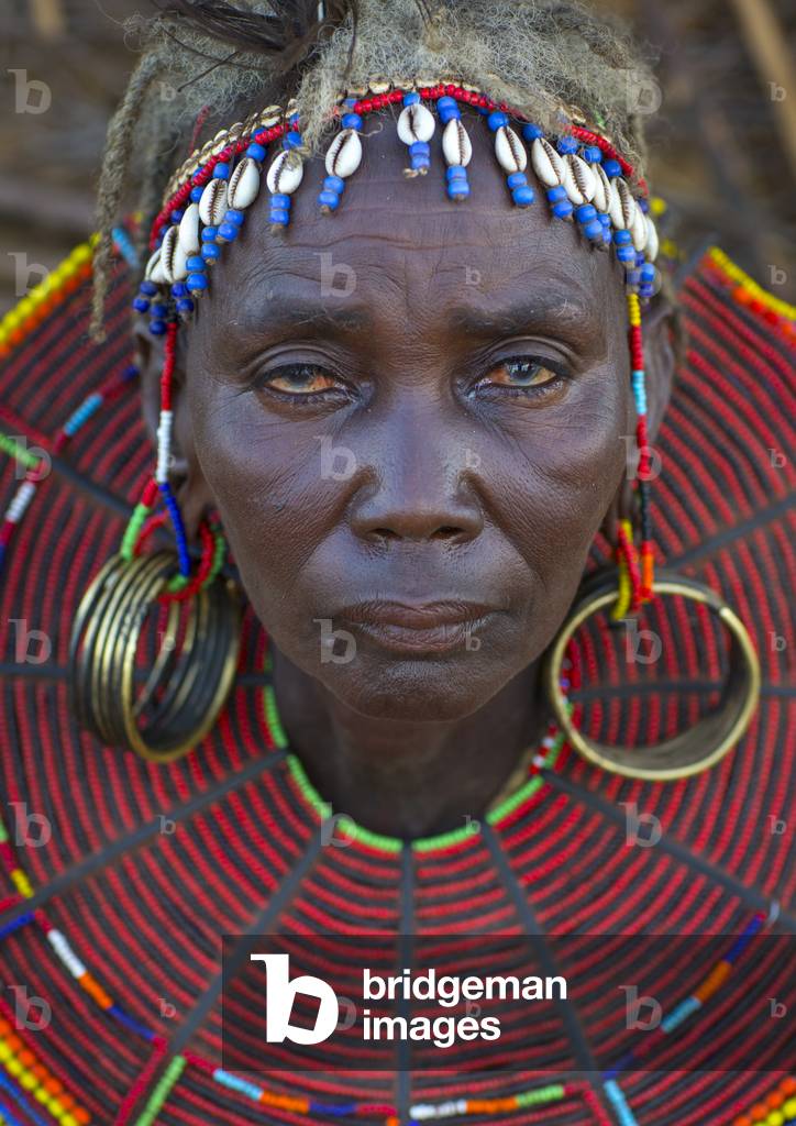 A pokot woman wears large necklaces made from the stems of sedge grass, Baringo county, Baringo, Kenya, Africa (photo)