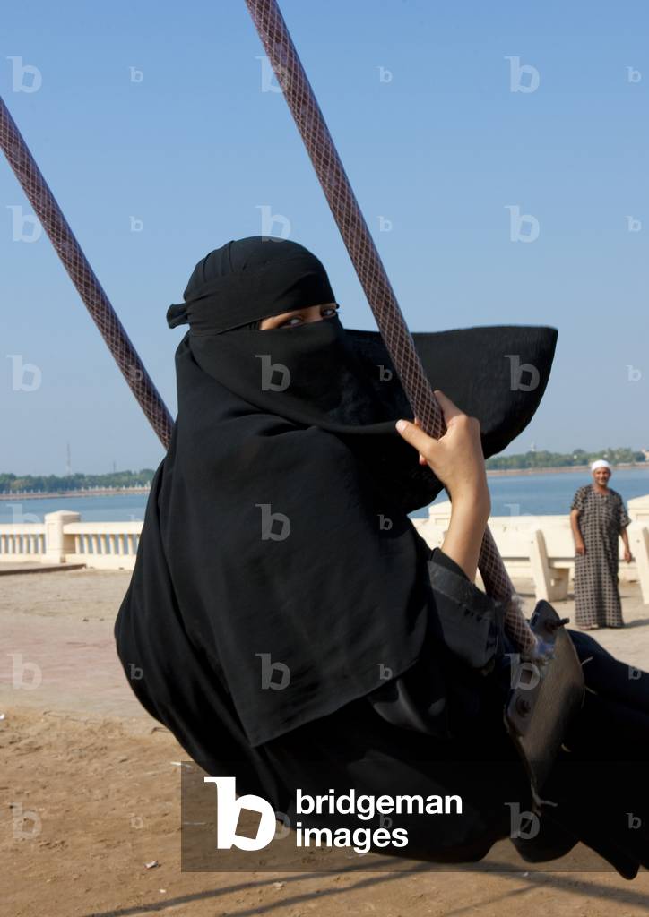 Girl in Abaya on a Swing, Jeddah, Mecca Region, Saudi Arabia (photo)
