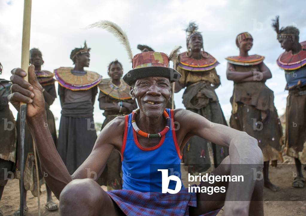 Pokot tribe people man pausing in front of the women, Baringo county, Baringo, Kenya, Africa (photo)