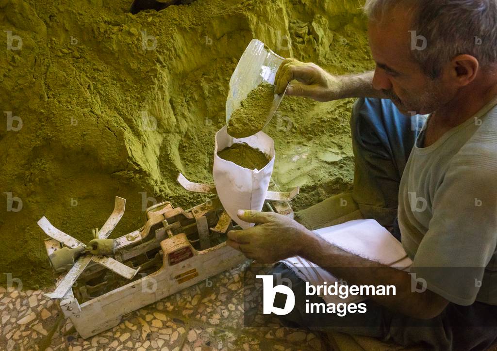 Iranian Worker Packing Henna Bags in a Traditional Mill, Yazd Province, Yazd, Iran (photo)