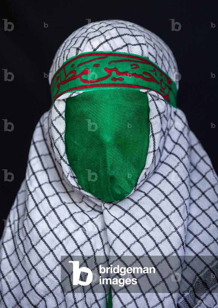 Iranian Young Man with Green Veil Covering His Face during Chehel Menbari Festival on Tasua to Commemorate the Martyrdom of Hussein, Lorestan Province, Khorramabad, Iran (photo)