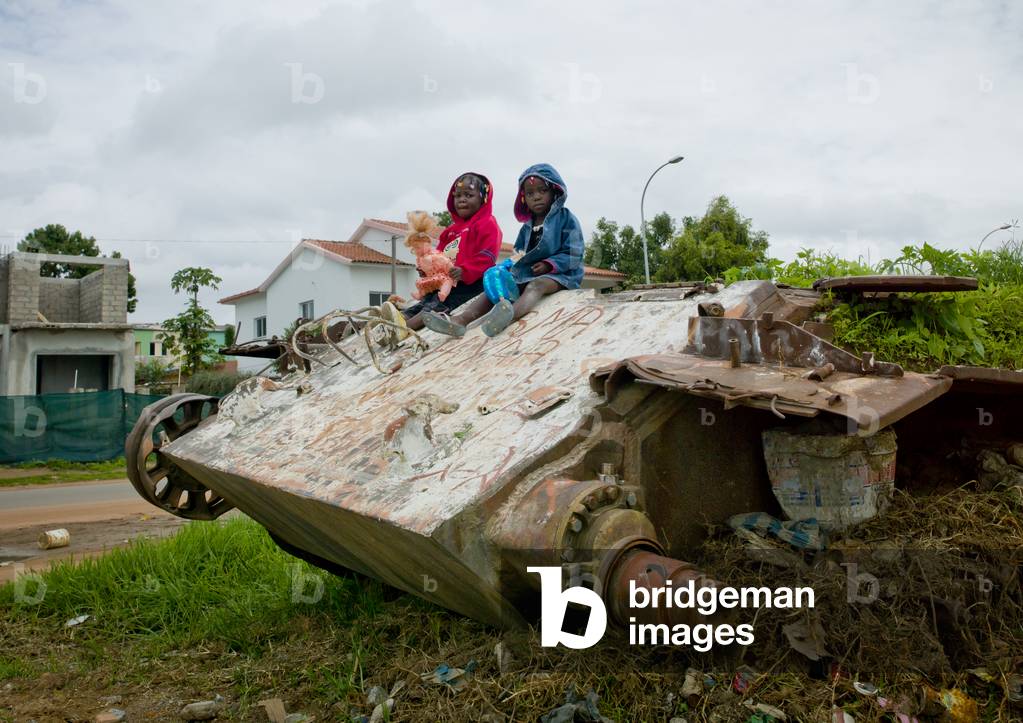 Kids on a Tank Wreck From Civil War, Angola, Africa (photo)