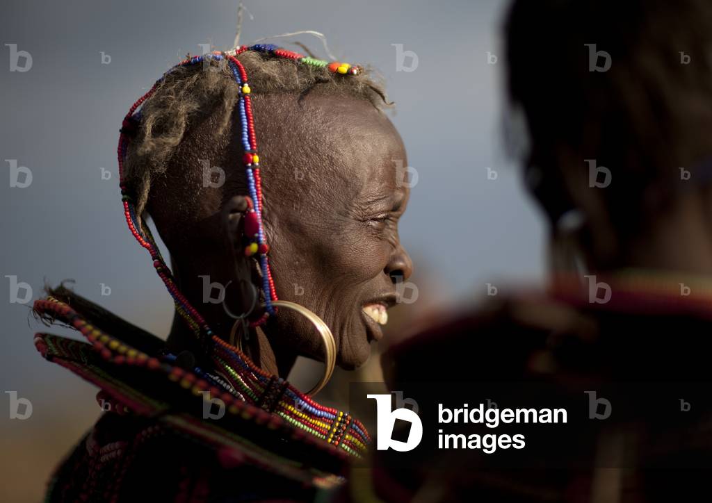 A pokot woman wears large necklaces made from the stems of sedge grass, Baringo county, Baringo, Kenya, Africa (photo)