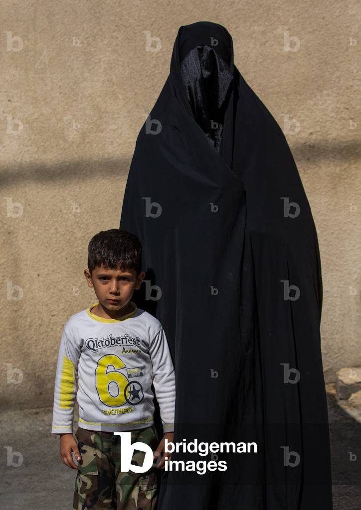 A Shiite Muslim Woman mourning Imam Hussein on the Day of Tasua with her Face Covered by a Veil, Lorestan Province, Khorramabad, Iran (photo)
