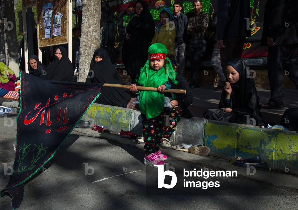 Iranian Shiite Girl with a Flag on Ashura, Kurdistan Province, Bijar, Iran (photo)