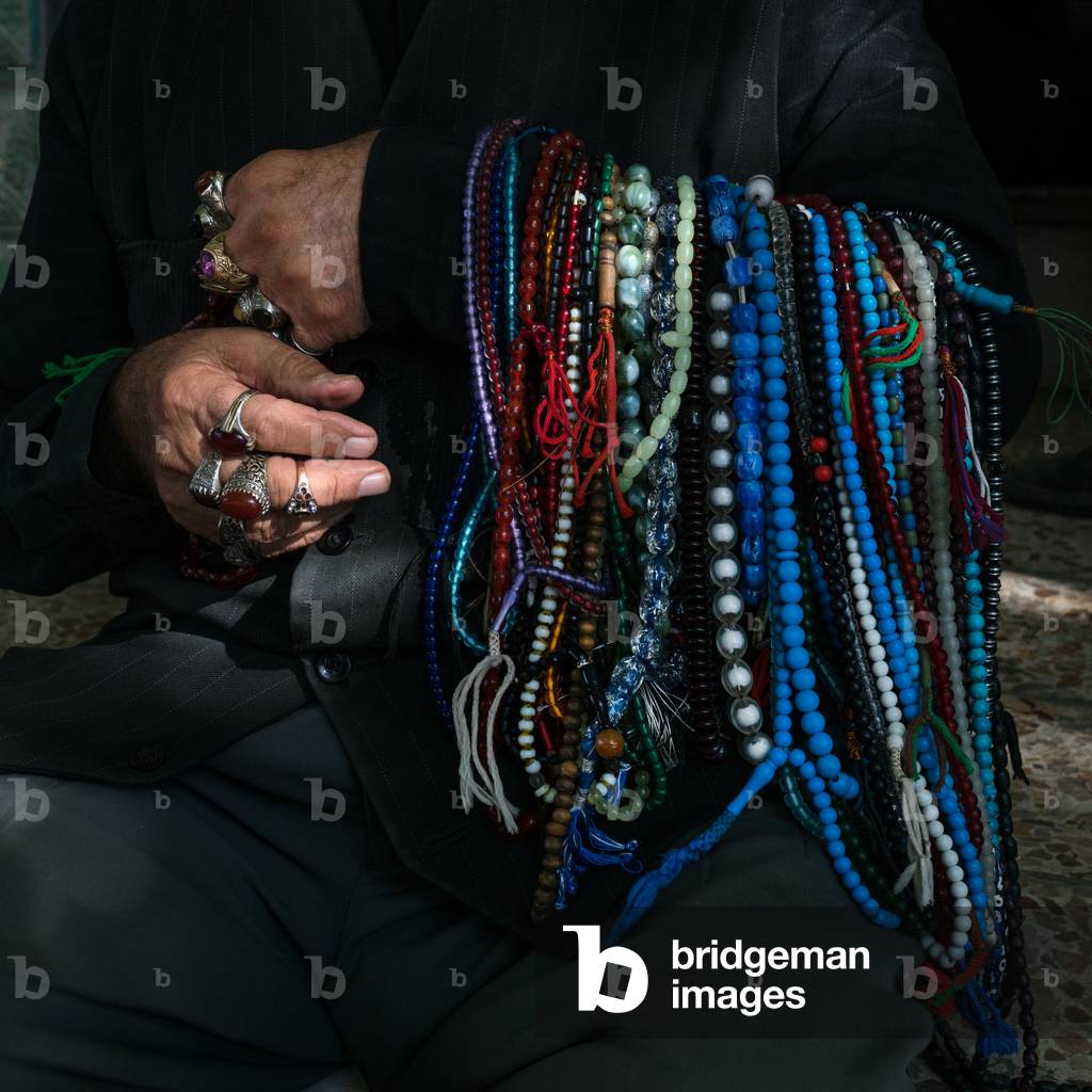 Man selling muslim prayer beads in the street for Ashura, Lorestan Province, Khorramabad, Iran (photo)