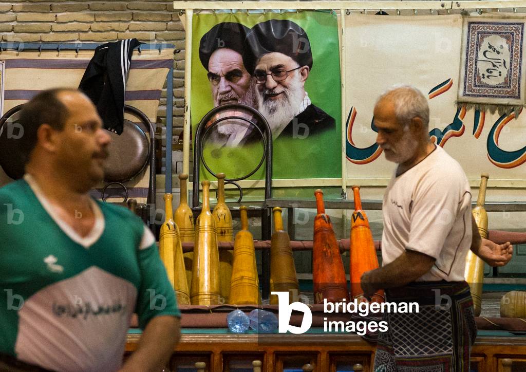 Men Training at Saheb a Zaman Club Zurkhaneh in front of Khameini and Khomeini Posters, Yazd Province, Yazd, Iran (photo)