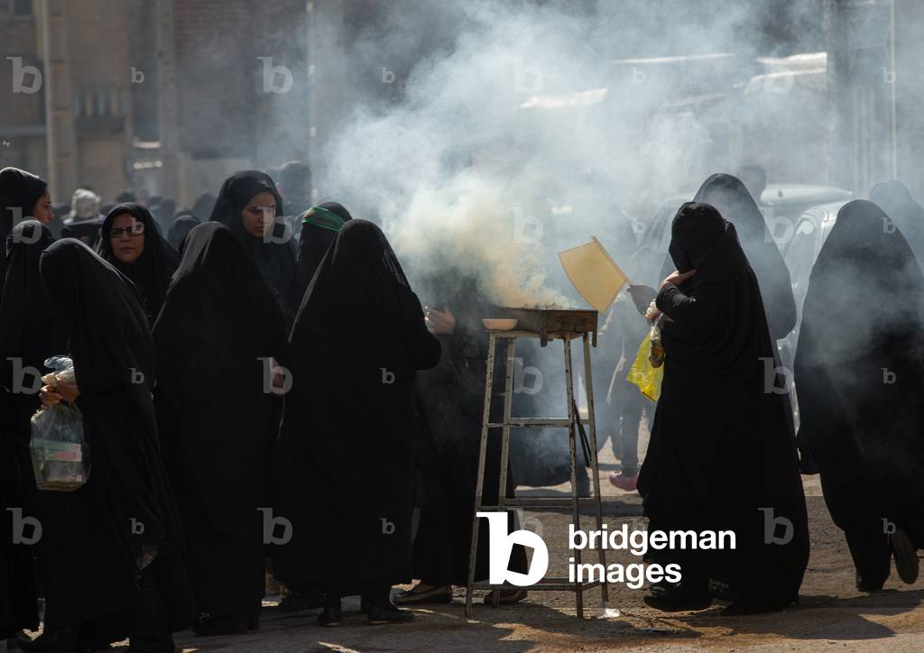 Shia Muslim Women Lighting Incense during Chehel Menbari Festival on Tasua Day for Ashura Celebration, Lorestan Province, Khorramabad, Iran (photo)