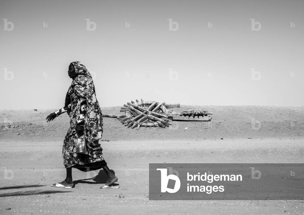 Nubian Woman Passing in Front of An Old Well, Delgo, Northern Province, Sudan (photo)