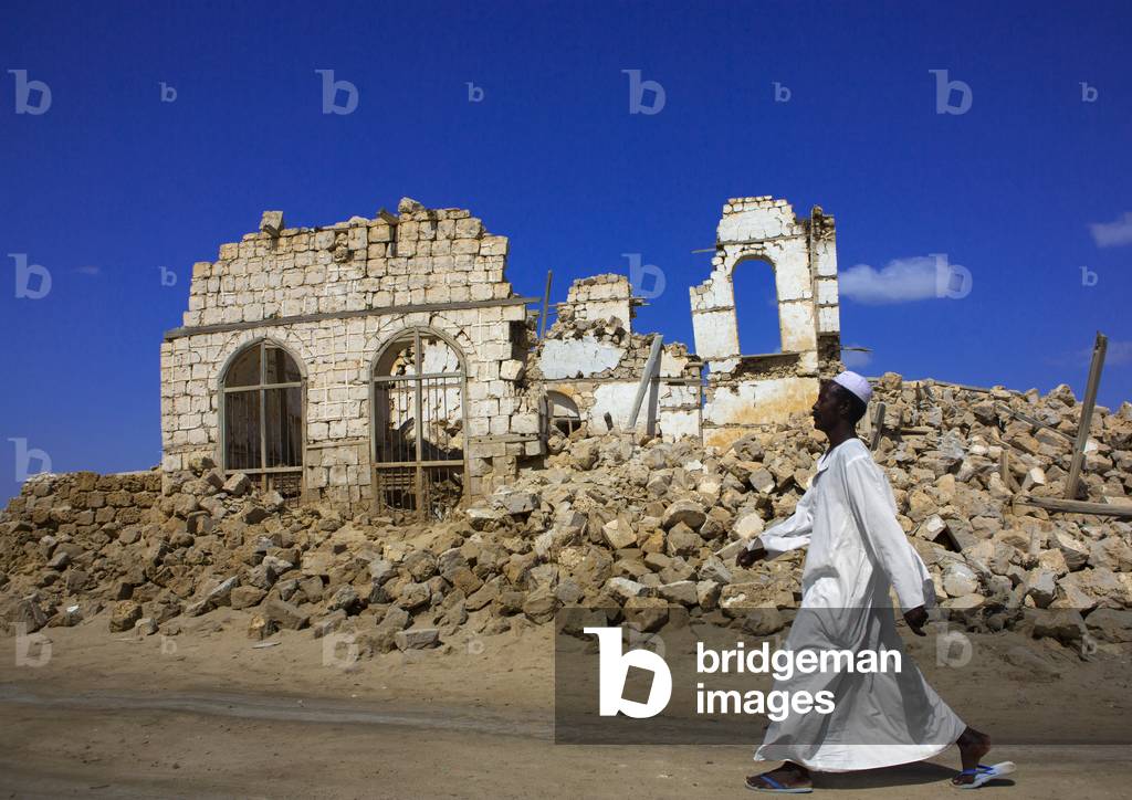 Man Passing in Front of a Ruined Ottoman Coral Buildings, Suakin, Port Sudan, Sudan (photo)