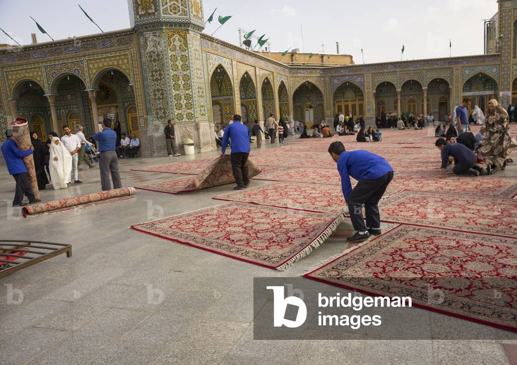 Men putting carpets for praying in the shrine of fatima al-masumeh, Qom province, Qom, Iran (photo)