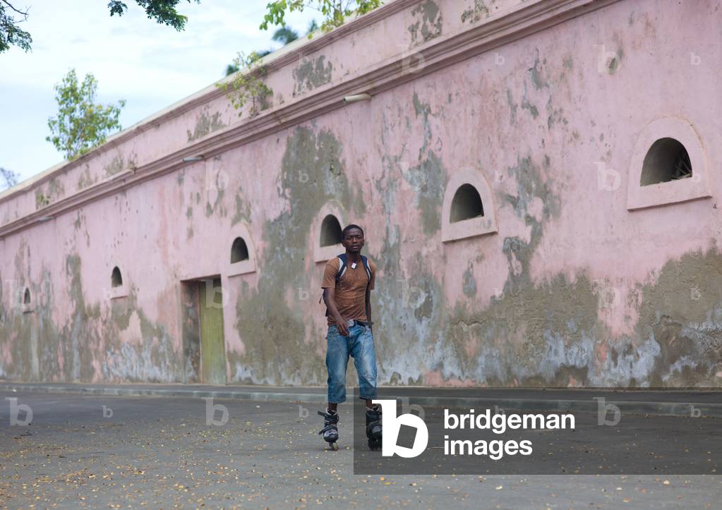 Young Man Doing Roller in front of the City Wall in Benguela, Angola, Africa (photo)