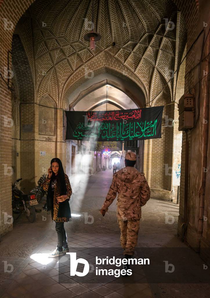 Woman and Soldier in an Empty Bazaar, Yazd Province, Yazd, Iran (photo)
