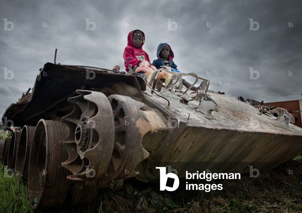 Kids on a Tank Wreck From Civil War, Angola, Africa (photo)