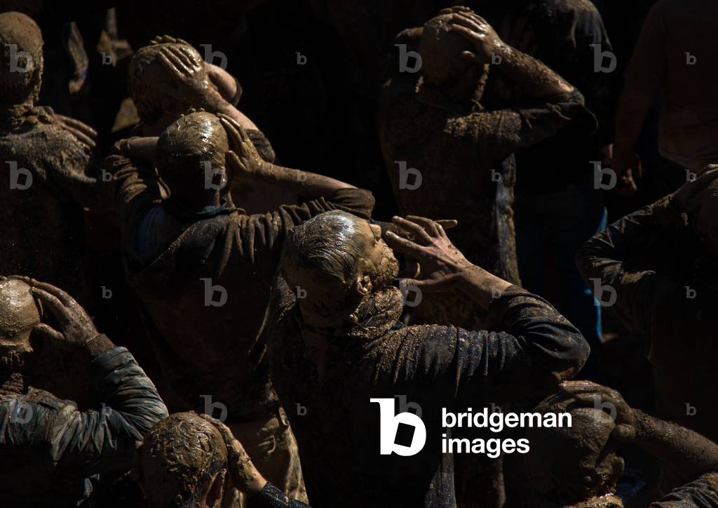 Iranian Shiite Muslim Men Covered in Mud, Chanting and Self-flagellating during Ashura, Kurdistan Province, Bijar, Iran (photo)
