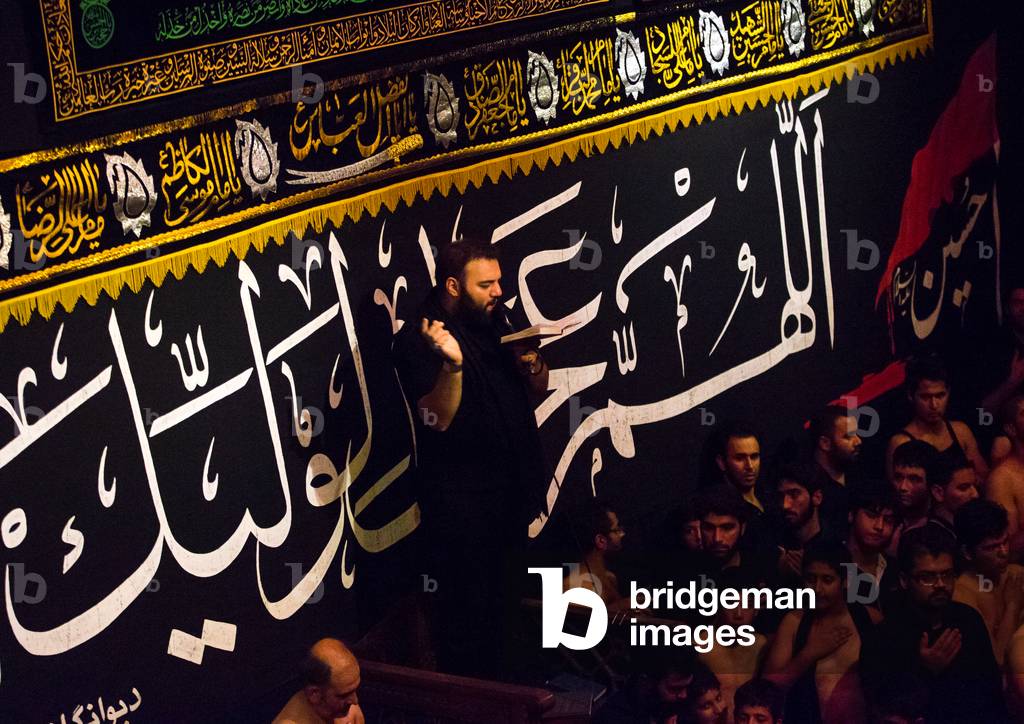 Iranian Shiite Muslim Man Leading Recitations and Songs with the Mad of Hussein Mourners during Muharram, Isfahan Province, Kashan, Iran (photo)