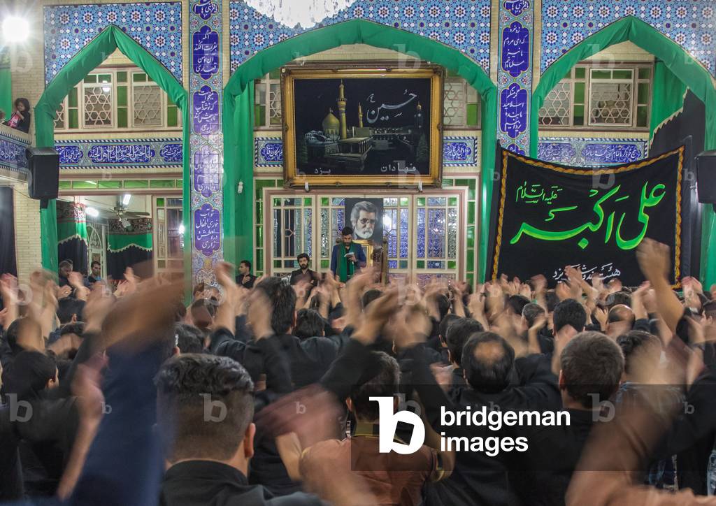 Iranian shiite muslim mourners chanting during Muharram inside Fahadan Hosseinieh, Yazd, Yazd Province, Iran (photo)