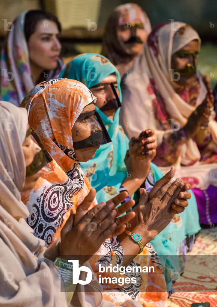 Women with traditional burqas masks during a zar ceremony, Qeshm Island, Salakh, Iran (photo)