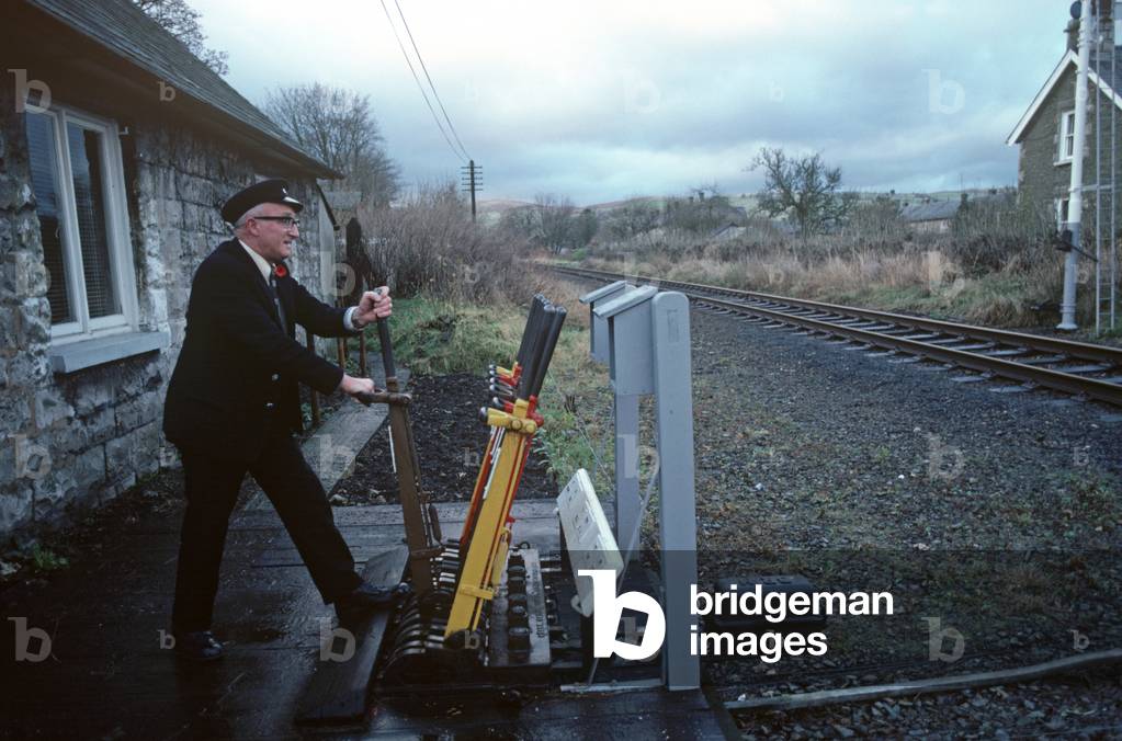 Level crossing keeper on the Oxenholme to Windermere, Lake District line, England, 1981 (photograph)