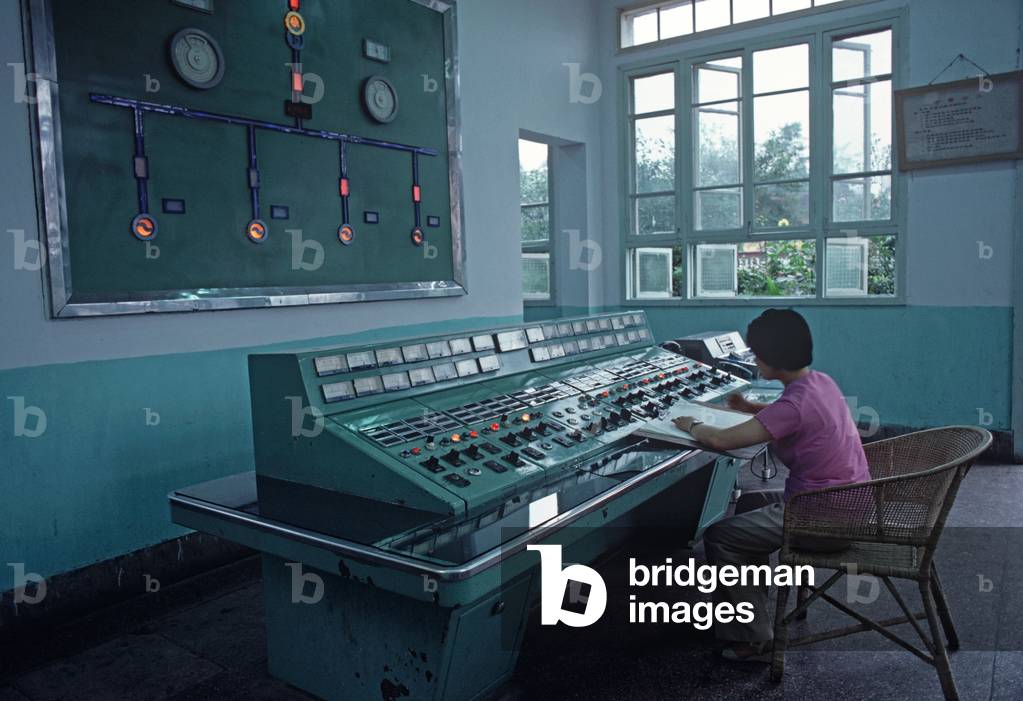 Chinese woman at control panel of Hydro electric plant in Chengdu, Sichuan Province, China (photo)