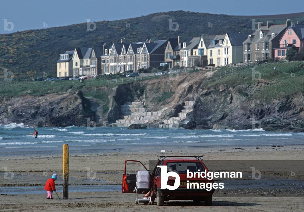 Child playing on Polzeath beach, North Cornwall, England, UK (photo)