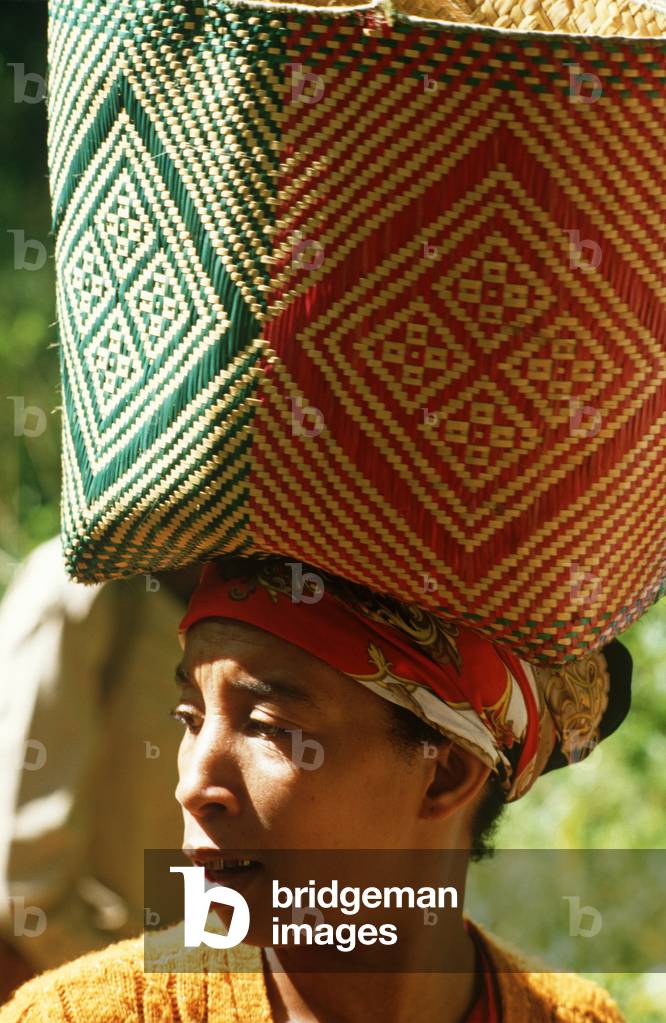 Woman with basket on head making way through Perinet reserve famous for its Lemurs, Madagascar, East Africa, Africa, 1980s (photo)