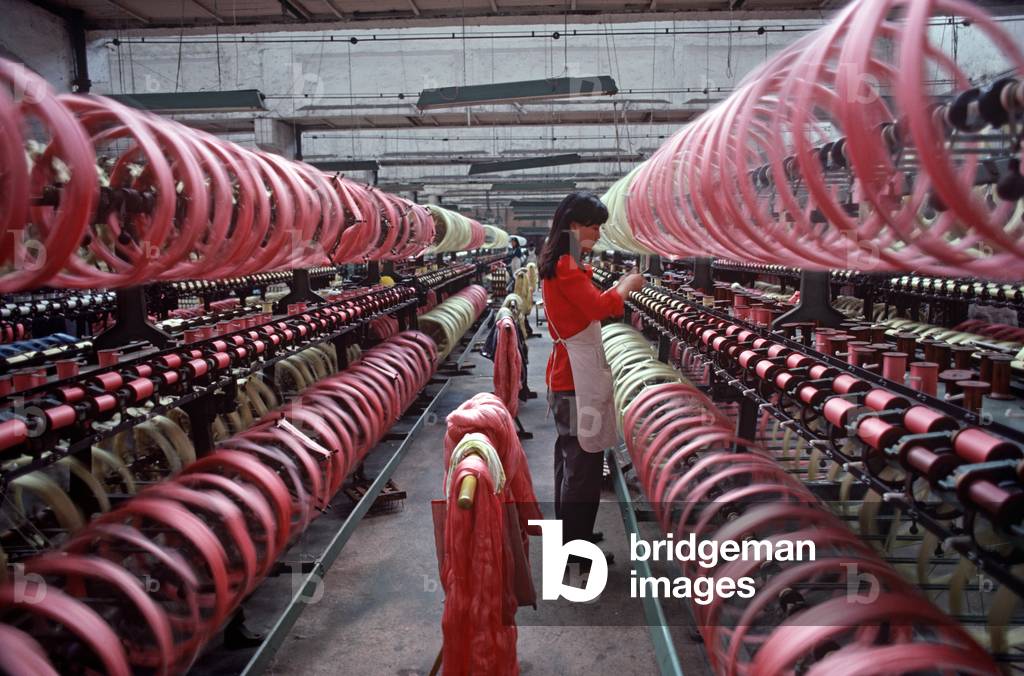 Spools of silk being put on to bobbins ready for weaving in the Chinese Silk Process, Hangzhou Silk Company factory, Hangzhou, Zheijang Province, China (photo)