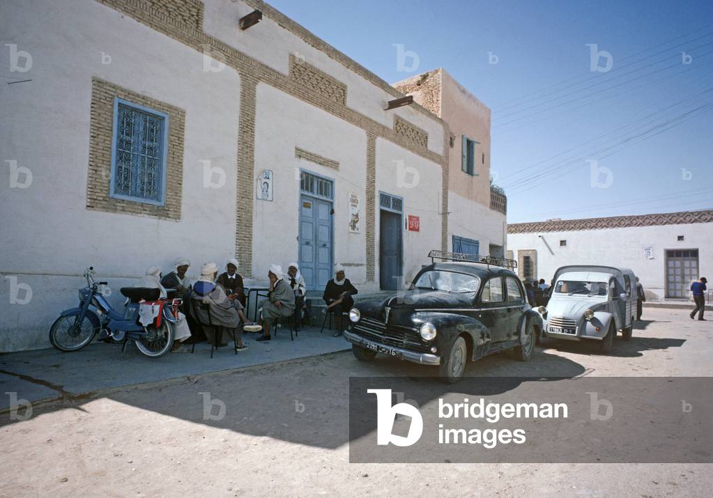 Arab Berber men sitting in shade outside cafe in South Tunisia cafe, Tunisia, North Africa (photo)