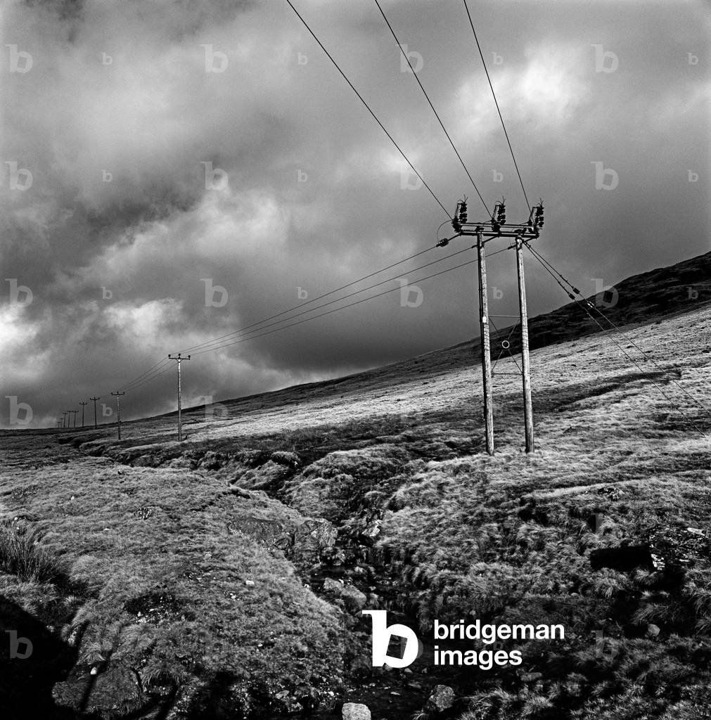 Electric power pole and cables, Mourne Mountains, Co Down, Northern Ireland (b/w photo)