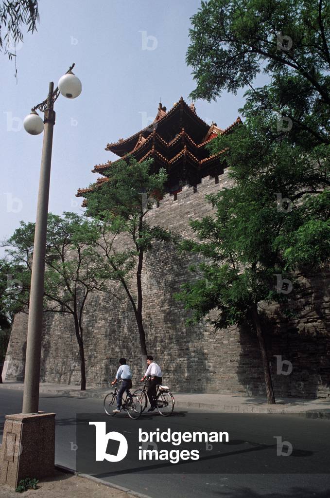 Cyclists in side street of Forbidden City, Beijing, China (photo)