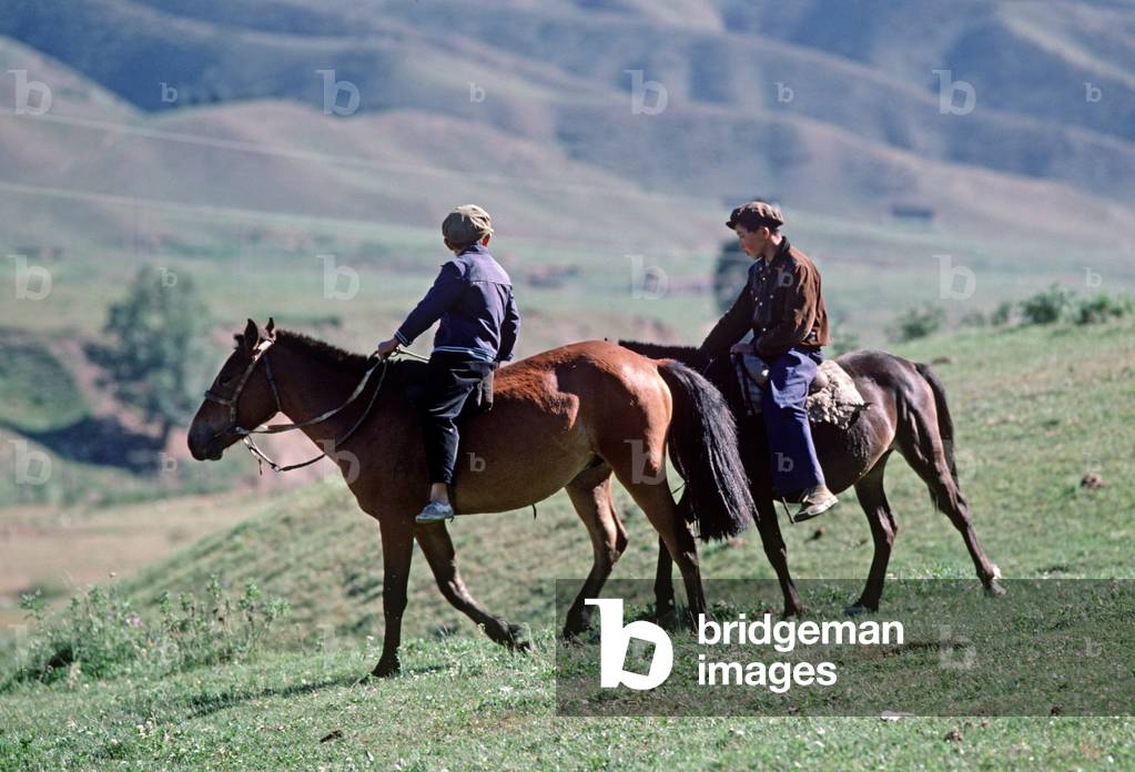 young Kazakh horsemen in hills North of Urumqi, Xianjiang Province, China (photo)