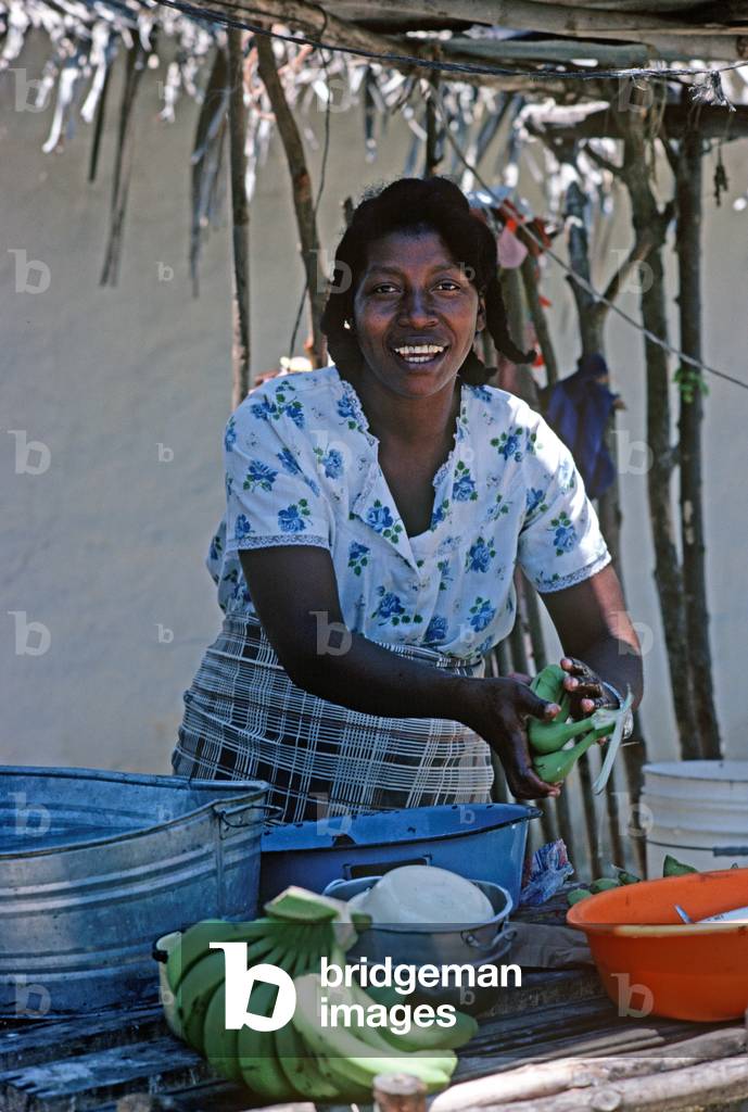 Woman washing bananas in village on Mosquito Coast, Honduras (photo)