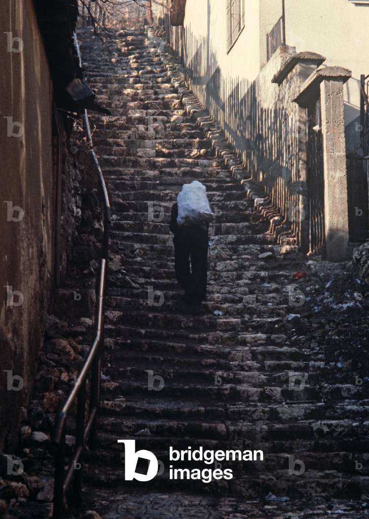 Delivery of coal up steep steps in old part of Sarajevo, former Yugoslavia