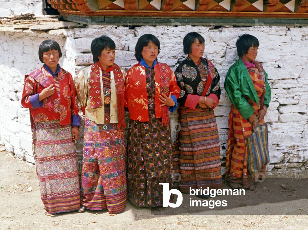 Bhutanese women in traditional costumes at the Paro Tshechu, mask dance festival, in the Paro Dzong, Bhutan (photo)