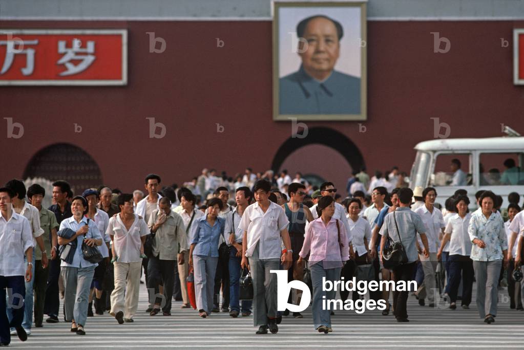Chinese tourists exiting Forbidden City with portrait of Chairman Mao, Tiananmen Square, Beijing, China (photo)