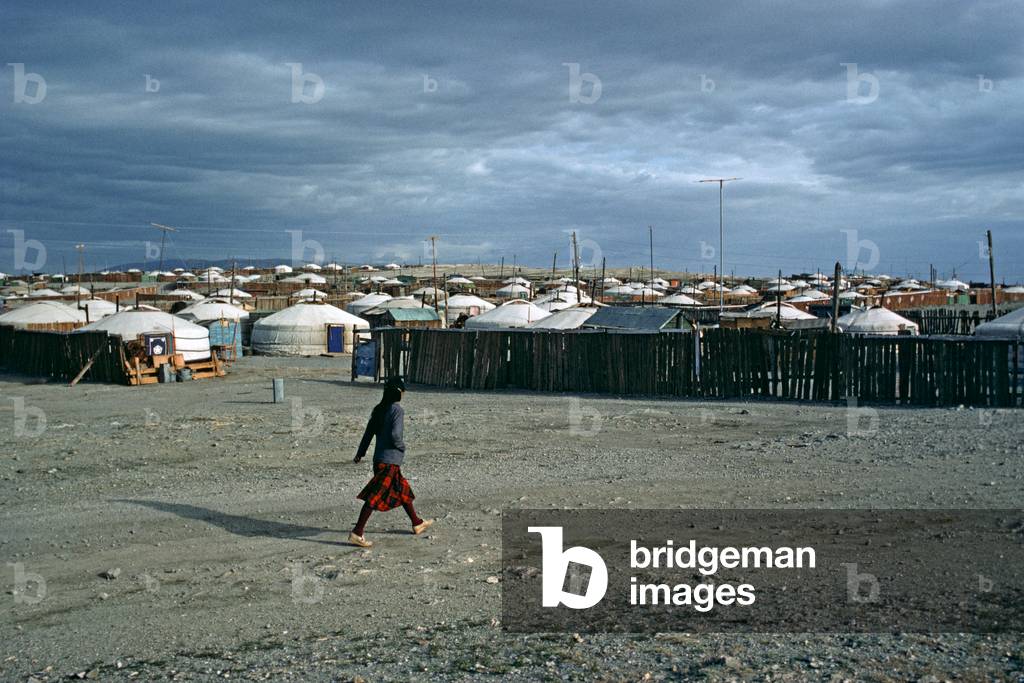 Mongolian woman walking past Yurt Village in Gobi-Altai, Gobi-Desert,  Mongolia, Asia