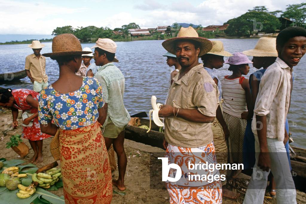 Buying fruit and vegetables from wooden canoes in Maroantsetra, Bay of Antongil, Madagascar, East Africa, Africa, 1980s (photo)