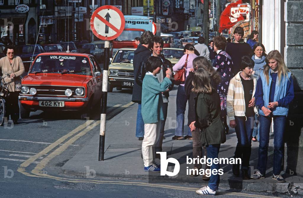 Youths congregating on Castlebar street corner, Co Mayo, Ireland (photo)