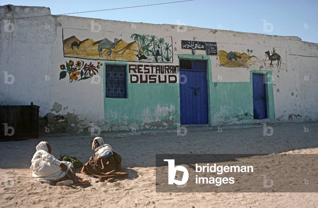 Arab Berbers resting in the shade infront of closed restaurant, Tozeur, South Tunisia, North Africa (photo)