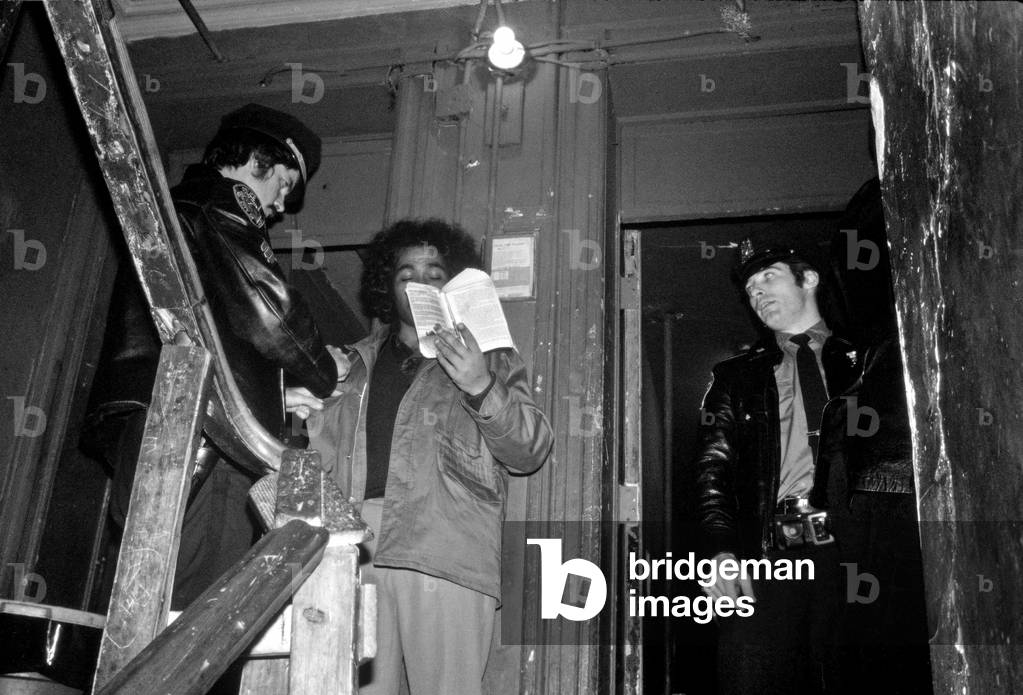 New York Cops stop and search on an African American in New York tenement building, Harlem, New York City, USA, 1970s (b/w photo)