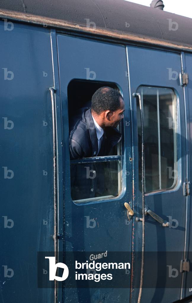 British Rail guard at Willesden Junction railway station on the North London Line, London, 1980s, 1982 (photograph)