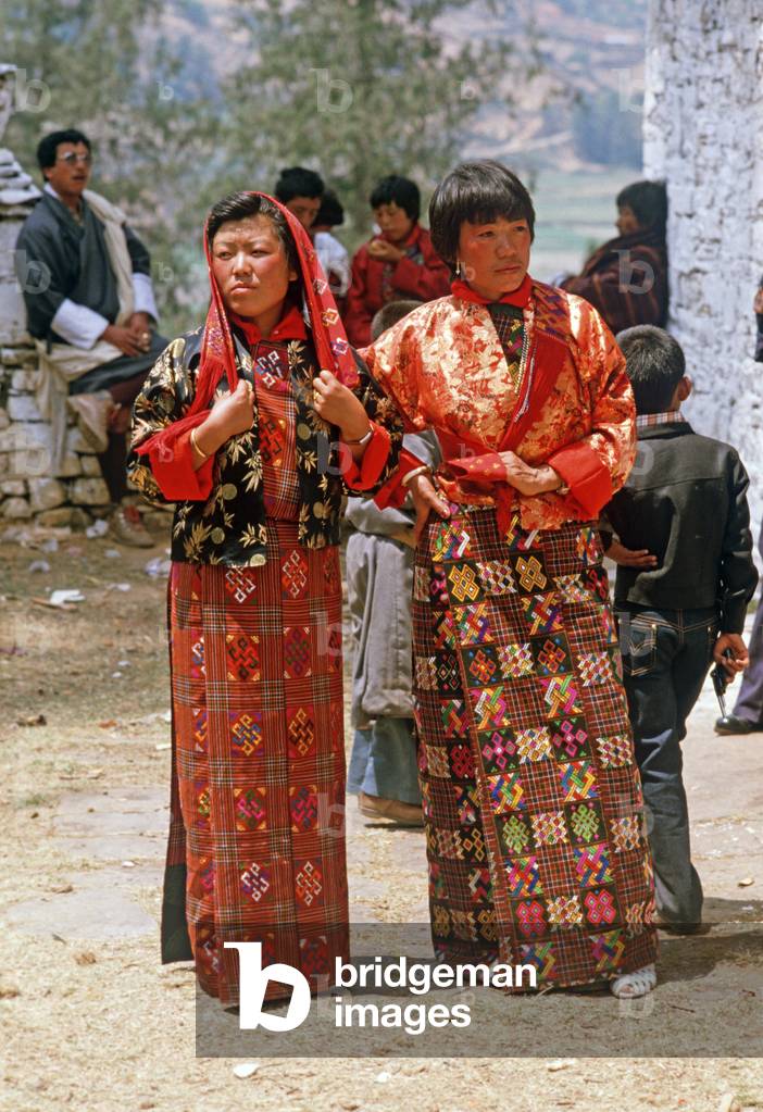 Bhutanese women in traditional costumes at the Paro Tshechu, mask dance festival, in the Paro Dzong, Bhutan (photo)