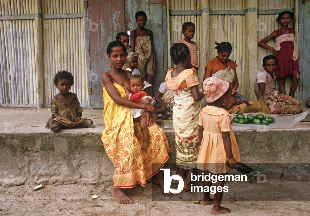 Mother breast feeding and children at Perinet market, Madagascar, East Africa, Africa, 1980s (photo)