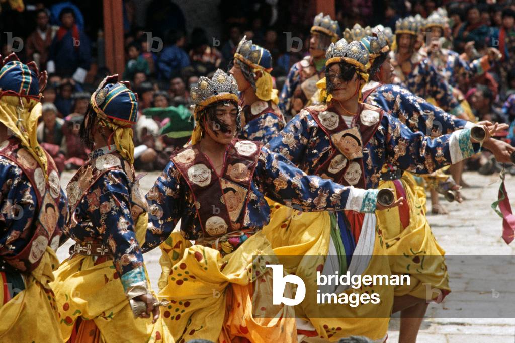 Bell dancers at the Paro Tshechu, mask dance festival, in the Paro Dzong, Bhutan (photo)