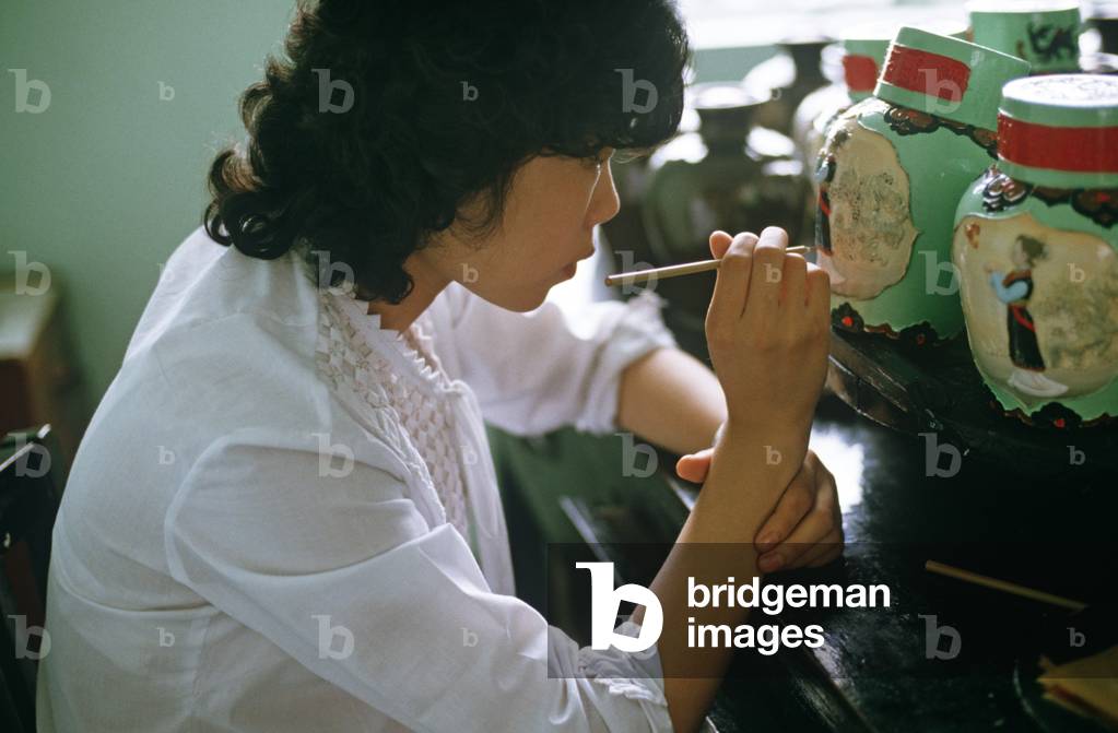 Chinese girl hand painting rice wine jars, Shaoxing Rice Wine factory, Shaoxing, China (photo)