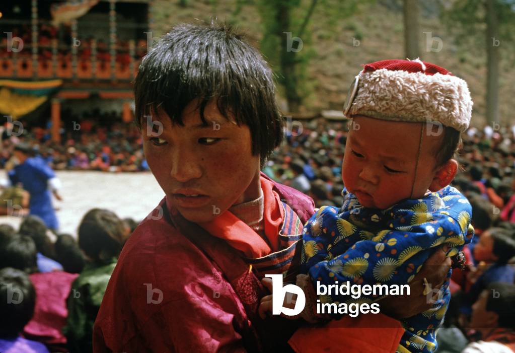 Bhutanese family at the Paro Tshechu, mask dance festival, in the Paro Dzong, Bhutan (photo)