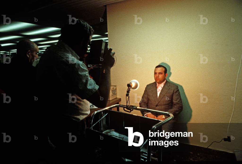 Georgian Jew having ID photo taken on arrival at Tel Aviv airport, Israel, 1980s (photo)